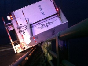 A male driver wasn't hurt when his transport tipped over on the Mackinac Bridge on Thursday, July 18, 2013.