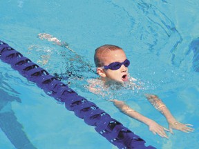 Eight-year-old Mason Osinchuk competes during the Devon Dolphins-hosted Freeze or Fry swim meet at the Devon outdoor pool on Saturday, July 13.