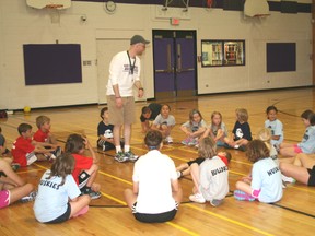 Trevor Belrose explains the rules of a game during a sports camp that focused on soccer and basketball. While soccer coaching was the main focus of Dr. Jean Cote's study, many of the findings relate to numerous sports and the importance of good coaching. 
GRACE PROTOPAPAS/KENORA DAILY MINER AND NEWS/QMI AGENCY