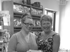 Pictured: Alisha Baker, a new staff member who is part of the special events team at the Chamber of Commerce presents Clarke with the cheque.