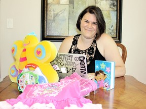 Kara Charron, of Blenheim, Ont. is surrounded by a sample of items moms can list to giveaway, or request, on a new Website www.frugalmommy.org to help their dollars stretch. The mother of two said there are no strings attached and response has been awesome.VICKI GOUGH/ THE CHATHAM DAILY NEWS/ QMI AGENCY