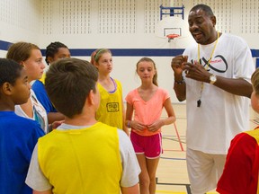 Micheal Ray Richardson, the coach of London Lightning talks to the kids attending a London Lightning basketball camp on July 8 in London. (QMI Agency file photo)