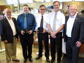 Richard Ponic and Greg Boyle, owners of Sarnia's Exmouth Street Tim Horton's, were recognized Friday for their commitment to hiring employees with disabilities. Ponic and Boyle began working with Community Living after attending an Ontario Rotary education program. From left are: Joe Dale of Ontario Rotary, Bob Vansickle of Community Living Sarnia Lambton, Ponic, Boyle and Torontonian Mark Wafer, a founding member of the Ontario Rotary at Work project. (CATHY DOBSON, The Observer)