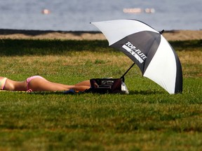 Laura Sutherland tans at Britannia Beach Thursday, July 18 2013.  Darren Brown/QMI Agency/Ottawa Sun