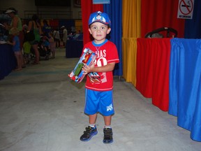 Alex Paez, 3, of Guelph, wears Thomas the Tank Engine-themed clothing and clutches a toy from the popular Thomas TV series on Friday, July 19, 2013, in St. Thomas. Paez was one of thousands expected to attend Day Out With Thomas, a mini-festival built around the popular children's character. The event runs from July 19-21 and July 26-28 at the St. Thomas-Elgin Memorial Centre. (Ben Forrest, Times-Journal)