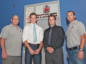 Brantford 99ers head coach Scott Rex (left) and general manager Mike Spadafora (right) pose with the team's latest signed players: Nathan Ferris and Keegan Alvestad, both of Brantford. (Brian Thompson, The Expositor)