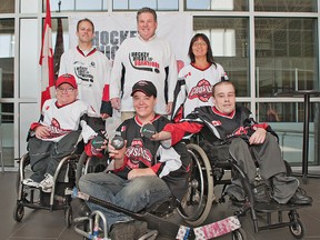 Joel Doherty (left) of Walton Development and Management joins Brant MP Phil McColeman on Friday morning at the Wayne Gretzky Sports Centre, along with Brant County Crushers sledge hockey team members (from left) Andrew Robb, Jessie Gregory, Steven Dowling and Tuyet Yurczyszyn.  The Crushers will play a split-squad game to demonstrate sledge hockey, right before the start of the Hockey Night in Brantford game on Aug. 14.(Brian Thompson, The Expositor)