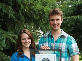 Jesse Fontaine and Breanna Broughton, both university students from Timmins, hold the official certificate they recently received recognizing them as Guinness World Record holders. The pair jointly hold the record playing the longest continuous game of air hockey ever. The game was played last year at the Bible Fellowship Assembly in Porcupine.