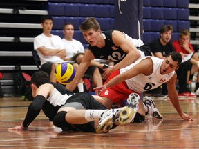 Canadian junior men's team left-side hitter Ryley Barnes (12), libero Jeremy Davies and left-side hitter Stephen Maar scramble to return a ball Friday during an exhibition game against the Ontario under-21 men's team at R.J. Surtees Student Athletics Centre. Team Canada, Mexico, Ontario, Alberta and Quebec are playing exhibition games, free of charge to spectators, at Nipissing University until Monday.