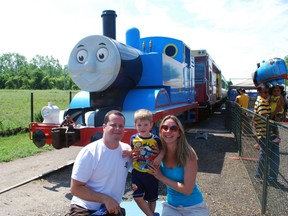 Day Out With Thomas has drawn large crowds in its first weekend at the St. Thomas-Elgin Memorial Centre. The event is a mini-festival built around the popular children's character Thomas the Tank Engine and is expected to draw tens of thousands of people to St. Thomas. Visitors are able to ride a life-sized replica of Thomas on real train tracks. In the above photo, Gustavo Nicolosi and Fabiana Trevisani pose with son Thomas Nicolosi, 2, in front of Thomas on Saturday. Ben Forrest/QMI Agency/Times-Journal