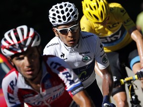 Overall leader's yellow jersey Britain's Christopher Froome (R) rides in the breakaway behind Colombia's Nairo Quintana (C) and Spain's Joaquim Rodriguez Oliver during the 125 km twentieth stage of the 100th Tour de France, July 20, 2013 in the French Alps.  (AFP PHOTO / JEFF PACHOUD)