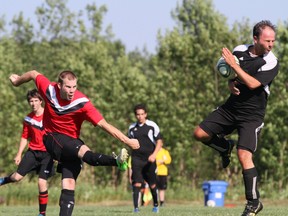 The Owen Sound Grey Motors United's Clark Green blasts a shot off the chest of East Gwillimbury's Vas Pivrnec in the first half of Owen Sound's 2-1 win on Saturday in York Region Soccer League men's premier division action.