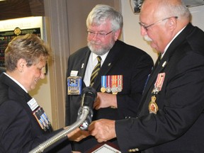 Waterford Legion president Sharon Anderson accepts her lifetime member pin from Royal Canadian Legion provincial president Bruce Julian, centre, and provincial vice president David Smith at the legion's 85th anniversary celebration on Friday night. (SARAH DOKTOR Simcoe Reformer)