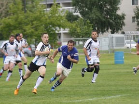 Evan Buckley advances the ball on Saturday against the Edmonton Pirates at Westwood Field in Thickwood. A late try put the Knights on top by a score of 25-20 for their first home victory.
Robert Murray/Today Staff