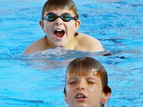 Matthew Kauk (top) and Nicholas Kauk both swim laps at the Delhi Kinsmen Pool on Thursday. The two swimmers are preparing for the upcoming Dave's Variety Invitational Swim on July 27.