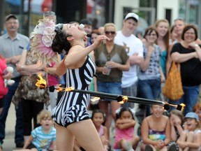 Kamikaze Fireflies Rob Williams and Casey Martin (pictured) wowed a crowd during a Friday performance at the Grande Prairie International Street Performers Festival. From standing on five chairs stacked to the sky, to hula hooping a ring of fire while catching marshmallows, the Kamikaze Fireflies didn’t disappoint the huge crowd. (Aaron Hinks/Daily Herald-Tribune)
