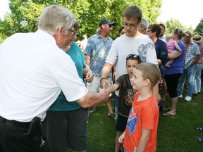 Oxford County MPP Ernie Hardeman greets some of the future voters who turned out for the annual free barbecue in Southside Park in Woodstock on Saturday, July 20, 2013. Hundreds of people lined up for the meal, which featured Oxford County pork and other local produce. JOHN TAPLEY/INGERSOLL TIMES/QMI AGENCY