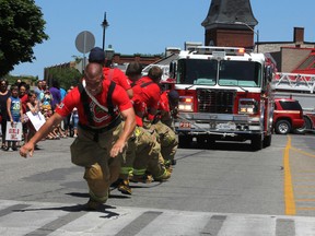 Members of the Kingston Fire and Rescue pull a fire truck during the annual Pull Together for Epilepsy fundraising and awareness event in Kingston on Sunday. (Danielle VandenBrink The Whig-Standard)