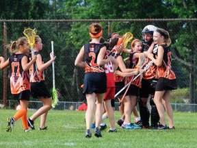 Members of the U13 team celebrate their win in Oshawa Saturday.  Congratulating their goalie are (L-R) Reese Wilkins, Morgan Kirk, Kenna McKee, Hana Solinger, Mallory McCoy, Grace Woods, Lauren Radbourne (goalie) and Katelynn Lavergne.