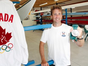 Former Olympian and president of Trenton Rowing and Paddling Club Jeff Lay holds his silver medal, which he won in men's rowing at the 1996 Atlanta Olympic Games.