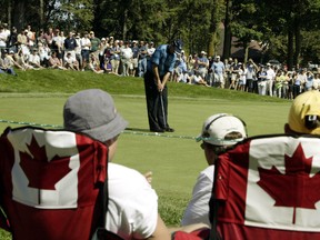 Golf fans watch Mike Weir putt during the Canadian Open in 2004. Weir would go on to lose in a playoff to Vijay Singh. (REUTERS)