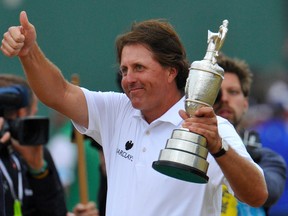 Phil Mickelson of the U.S. celebrates as he holds the Claret Jug after winning the British Open golf championship at Muirfield in Scotland July 21, 2013.         REUTERS/Toby Melville (BRITAIN  - Tags: SPORT GOLF)