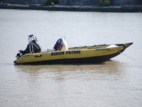 A Port Stanley Beach Patrol rescue boat floats just offshore on Saturday, July 20, 2013. The beach patrol and other rescue workers responded Saturday to a man in the water who suffered medical distress and later died in hospital. Ben Forrest/QMI Agency/Times-Journal