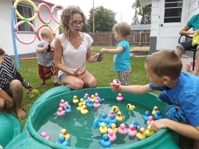 Carly Moran mans the duck pond station at a mini carnival in her 8th Street N.E. yard on July 18. (Kayla Cool/Submitted photo)