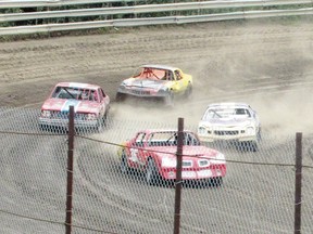 Drivers jockey for the lead while MC Suzanne (Barbie) Carlson keeps the crowd focused in the first street race of the day at Sangudo Speedway on Saturday, July 20, the first day of the two-day event. The winner was Scott Muyotte of Drayton Valley.