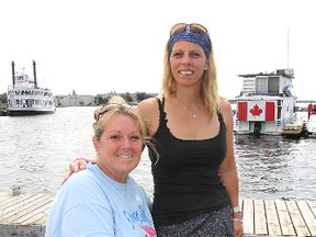 Colleen Shields, seated, and Nicole Mallette, two of the five women who will leave Kingston Tuesday morning on a 300-km swim to Burlington, meet next to the dock in Confederation Park that will be the start of their endeavour.
Michael Lea The Whig-Standard