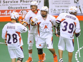 Jordan Durston (No. 8) of the Arrows is surrounded by his teammates after scoring a first-period goal against the Peterborough Jr. Lakers Monday in Game 1 of the best-of-seven Ontario Junior A Lacrosse League semifinal series at the Iroquois Lacrosse Arena. (Darryl G. Smart, The Expositor)