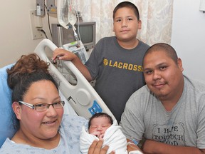 Kerri Henhawk and Alex Crawford of Ohsweken, along with their 10-year-old-son Evan Lickers welcome Denali Henhawk-Crawford, born Monday morning at Brantford General Hospital. (Brian Thompson, The Expositor)