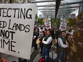 In this file photo, Native protesters gather outside the annual general meeting of Taseko Mines in Vancouver, British Columbia June 1, 2012. The native groups are fighting a proposal that the provincial government has approved allowing Taseko build an open pit copper mine in the area that would involve draining Fish Lake. (REUTERS/Andy Clark )