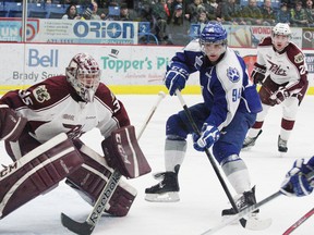 Brody Silk, right, of the Sudbury Wolves, looks for a rebound as goalie Michael Giugovaz, of the Peterborough Petes, keeps an eye on the puck during OHL action at the Sudbury Community Arena on Friday, March 1, 2013. JOHN LAPPA/THE SUDBURY STAR/QMI AGENCY
