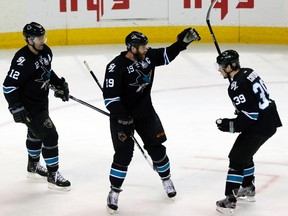 San Jose Sharks center Joe Thornton (19) celebrates his first period goal against the Los Angeles Kings with teammates Logan Couture (39) and Patrick Marleau (12) during Game 6 of their NHL Western Conference semi-final playoff hockey game in San Jose, California May 26, 2013.