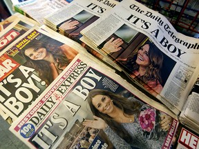 British newspapers are seen in a shop in Notting Hill in London, Tuesday, July 23. The world was awaiting the first glimpse of Britain's new prince on Tuesday, with camera crews poised to photograph Britain's Prince William and his wife, Catherine, Duchess of Cambridge leaving the Lindo Wing of St Mary's Hospital with their baby son. Kate gave birth to the couple's first child, who is third in line to the British throne, on Monday afternoon, ending weeks of feverish anticipation about the arrival of the royal baby.  REUTERS/Neil Hall