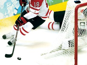 Canada's Mike Richards comes around the net with the puck during first period action of Olympic men's hockey playoff quarterfinals at GM Place in Vancouver, B.C., on Wednesday, Feb. 24, 2010 between Team Canada and Team Russia. 
ANDRE FORGET/QMI AGENCY