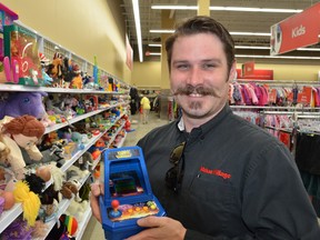 Value Village store manager Mark Henderson awaits the rush of treasure hunters and bargain hunters alike when the store opens Thursday. Value Village will resell donated used clothing and other household items from its new 16th St. E. store.