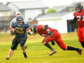 The Drillers’ Bodie Criddle is stopped by the Central Alberta Buccaneers in Alberta Football League play in the pouring rain, Saturday at St. Joe’s field. The Buccaneers won 38-2. (Diana Rinne/Daily Herald-Tribune)