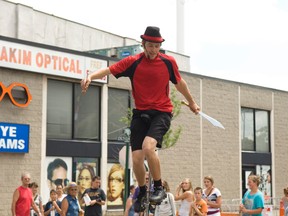 Professional juggler Ben Burland from Toronto preformed for the large crowd at the 35th Annual Summer Streetfest downtown Woodstock Thursday afternoon. Photo by Adrienne Eisen