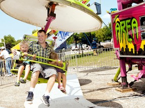 Area 51 amusement riders Cohen, left, his dad Adam and sister Chloe Johnston  enjoyed themselves on Saturday, July 28, 2012 at the Dresden Exhibition in Dresden, On. (QMI Agency)