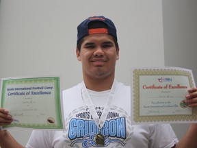 Brendon Sitko poses with his two certificates and the medal he was awarded for his performance at Patrick Chung’s Football Camp in Massachusetts earlier this month.   Robert Murray/Today STAFF