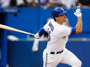 A night after staying up late to chat with teammates about a lopsided loss, Mark DeRosa of the Blue Jays hits a home run against the Los Angeles Dodgers in the fourth inning Tuesday. (REUTERS)
