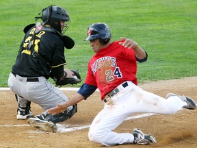 Winnipeg Goldeyes left fielder Fehlandt Lentini (r) beats Sioux Falls Canaries catcher Kevin Dultz for a run during American Association baseball in Winnipeg, Man. Tuesday July 23, 2013.
BRIAN DONOGH/WINNIPEG SUN/QMI AGENCY