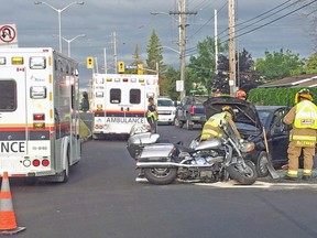 Firefighters check out a car and motorcycle which were involved in a crash on Walkley Rd. near Russell Rd. Wednesday morning. A motorcyclist was injured in the mishap, but the extent of the person's injuries were not immediately known. Traffic in the area was slowed as rescue crews worked at the scene and police investigated the crash. (BRIAN SAUVE Submitted image)