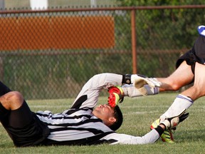 A Quinte Hellenics player dives over the Campbellford goalkeeper Calahan Duguay during Bay of Quinte Men's Soccer League First Division action last Thursday at Zwick's Park. Hellenics won 4-1.