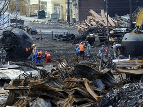 Workers clean up the site of the Lac-Megantic train derailment tragedy. (Stevens Leblanc/QMI Agency Files)