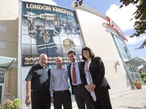 London Knights General Manager Mark Hunter, left, stands outside of Budweiser Gardens with Dwayne Blais, Director of Hockey Operations for Total Package Hockey Canada, Blyth Academy VP of Admissions and Recruitment Cameron Harvey, and Blyth Academy Head of School for London Jennifer Flynn-Clark, after an announcement the three are partnering together to open a hockey academy.  The group is pictured here in London on Wednesday July 24, 2013. (CRAIG GLOVER, The London Free Press)