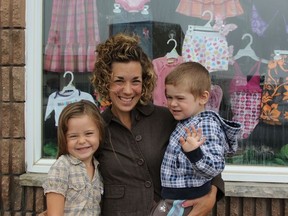 Tracey Lalonde, and her kids Diamond and Cash, stand outside of the family's newly opened thrift store on 6th Avenue, Thrif-T's. Missing from the photo is Tracey's husband Chris Lalonde.