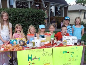Cochrane’s very own Shane , third from the right with the red shirt,  was the main voice of encouragement in the lemon aid stand that quickly came to include hot dogs.